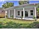 Covered outdoor patio, perfect for outdoor seating, overlooking a landscaped lawn at 1510 Live Oak St, New Smyrna Beach, FL 32168