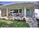 Charming front porch with beautiful tile, a seating area, and updated landscaping at 1510 Live Oak St, New Smyrna Beach, FL 32168