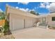 Spacious two-car garage with a private entrance to the home, complemented by a picket fence at 1510 Live Oak St, New Smyrna Beach, FL 32168