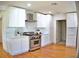 Modern kitchen features white cabinets, stainless steel appliances, and tile backsplash at 1510 Live Oak St, New Smyrna Beach, FL 32168