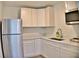 Modern kitchen featuring white cabinets, stainless steel appliances, a corner sink, and light countertops at 1510 Live Oak St, New Smyrna Beach, FL 32168
