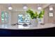 Bright kitchen island boasts quartz countertops and a stylish pendant lighting at 1510 Live Oak St, New Smyrna Beach, FL 32168