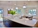 Spacious kitchen island with quartz countertop, modern pendants, and view to dining area at 1510 Live Oak St, New Smyrna Beach, FL 32168