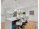 Modern kitchen island with seating, pendant lights, and a seamless flow to the dining and living areas at 1510 Live Oak St, New Smyrna Beach, FL 32168