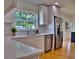 Close-up of kitchen featuring quartz countertops and stainless steel appliances at 1510 Live Oak St, New Smyrna Beach, FL 32168