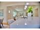 Open layout with white kitchen island, modern pendants, and view to living room at 1510 Live Oak St, New Smyrna Beach, FL 32168