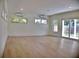 Open living room featuring hardwood floors, recessed lighting, and natural light, and two wall-mounted AC units at 1510 Live Oak St, New Smyrna Beach, FL 32168