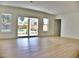 Bright living room featuring hardwood floors, white trim, and sliding glass doors leading to the back deck at 1510 Live Oak St, New Smyrna Beach, FL 32168