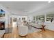 Bright, open living area with hardwood floors, fireplace, neutral tones, and seamless flow to dining area at 1510 Live Oak St, New Smyrna Beach, FL 32168