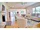 Spacious living room with a fireplace, hardwood flooring, and view to open concept kitchen and dining at 1510 Live Oak St, New Smyrna Beach, FL 32168