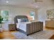Comfortable main bedroom with natural light, hardwood floors, ceiling fan, and stylish furnishings at 1510 Live Oak St, New Smyrna Beach, FL 32168