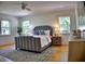 Serene main bedroom featuring hardwood floors, a ceiling fan, and plenty of natural light at 1510 Live Oak St, New Smyrna Beach, FL 32168