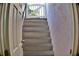 Outdoor painted stairs leading to a sunny space with a white gate and gray stone treads at 1510 Live Oak St, New Smyrna Beach, FL 32168