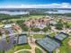 Aerial view of the community, with a lake, tennis courts and club house at 16246 Ravenna Ct, Montverde, FL 34756
