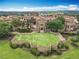 Aerial view of a community featuring a central lawn, water features and stone buildings at 16246 Ravenna Ct, Montverde, FL 34756