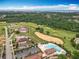Community aerial view showing golf course, and clubhouse with pool and parking at 16246 Ravenna Ct, Montverde, FL 34756