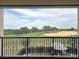 Relaxing balcony view overlooking a lush green golf course and a scenic landscape at 16246 Ravenna Ct, Montverde, FL 34756