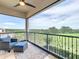 Inviting balcony with comfortable seating area and panoramic views of the surrounding greenery at 16246 Ravenna Ct, Montverde, FL 34756