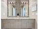 Bright bathroom features a double sink vanity with granite countertops and decorative mosaic backsplash at 16246 Ravenna Ct, Montverde, FL 34756
