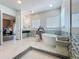 Elegant bathroom with soaking tub, glass-enclosed shower, and modern vanity at 16246 Ravenna Ct, Montverde, FL 34756