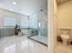 Bright bathroom featuring a soaking tub and glass shower with decorative tile backsplash at 16246 Ravenna Ct, Montverde, FL 34756