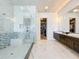 Luxurious bathroom boasts a glass-enclosed shower, double vanities, and walk-in closet at 16246 Ravenna Ct, Montverde, FL 34756