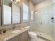 Bathroom features a glass shower, granite counters, and a modern sink with a window letting in light at 16246 Ravenna Ct, Montverde, FL 34756