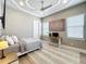 Bedroom with neutral tones, decorative rug, a desk, and large window with natural light at 16246 Ravenna Ct, Montverde, FL 34756