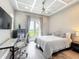 Bright bedroom with a ceiling fan, a balcony view, and hardwood floors at 16246 Ravenna Ct, Montverde, FL 34756