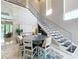 Stylish dining area with modern staircase and contemporary decor, perfect for entertaining guests at 16246 Ravenna Ct, Montverde, FL 34756