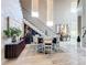 Spacious dining area features a modern table, staircase, and adjacent wine bar at 16246 Ravenna Ct, Montverde, FL 34756