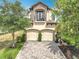 Beautiful two-story home with a two-car garage, balcony, manicured landscaping, and a brick driveway at 16246 Ravenna Ct, Montverde, FL 34756