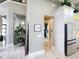 Hallway featuring bright white cabinets with marble floors and views into other rooms at 16246 Ravenna Ct, Montverde, FL 34756