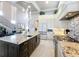 Open kitchen with granite countertops, a large island, stainless steel appliances, and tall white cabinets at 16246 Ravenna Ct, Montverde, FL 34756
