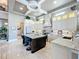 Bright modern kitchen with granite countertops, white cabinets, and a large central island at 16246 Ravenna Ct, Montverde, FL 34756
