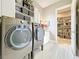 Well-equipped laundry room with modern washer and dryer, storage, and pantry at 16246 Ravenna Ct, Montverde, FL 34756