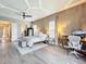 Bright and airy bedroom with wood floors, tray ceiling, and access to an office space at 16246 Ravenna Ct, Montverde, FL 34756