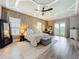 Spacious bedroom with tray ceiling, balcony, and ensuite office space at 16246 Ravenna Ct, Montverde, FL 34756