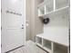 Functional mudroom with built-in bench, storage shelves, and coat hooks at 16246 Ravenna Ct, Montverde, FL 34756