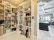 Spacious pantry boasts ample shelving, providing generous storage alongside kitchen and dining areas at 16246 Ravenna Ct, Montverde, FL 34756