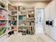 Well-organized pantry features generous open shelving and convenient access to adjacent rooms at 16246 Ravenna Ct, Montverde, FL 34756