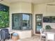 Cozy patio with dining area, fireplace, TV, lush landscaping, and view of the pool at 16246 Ravenna Ct, Montverde, FL 34756
