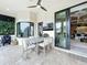 Inviting outdoor patio with dining area, fireplace, TV, and sliding glass doors at 16246 Ravenna Ct, Montverde, FL 34756