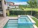 Beautiful pool and spa with lush backyard greenery and view of the neighboring properties at 16246 Ravenna Ct, Montverde, FL 34756