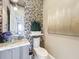 Stylish powder room boasts unique decorative accents and is conveniently located for guests at 16246 Ravenna Ct, Montverde, FL 34756