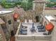 A spacious rooftop terrace with lounge chairs and stone detailing throughout at 16246 Ravenna Ct, Montverde, FL 34756