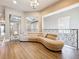 Sitting area featuring a comfortable sofa, wood floors, and decorative metal railing at 16246 Ravenna Ct, Montverde, FL 34756