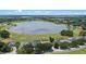 Beautiful home with screened in lanai and nice landscaping, situated near a serene lake at 16729 Tall Grass Ln, Clermont, FL 34711