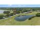 Enjoy views of the nearby lake from your home, nestled amongst lush trees and foliage at 16729 Tall Grass Ln, Clermont, FL 34711