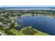Expansive lake surrounded by houses in a residential neighborhood, aerial view at 16729 Tall Grass Ln, Clermont, FL 34711